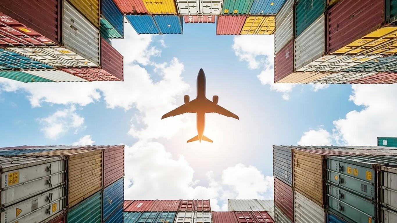 Shipping containers stacked at a port, seen from below